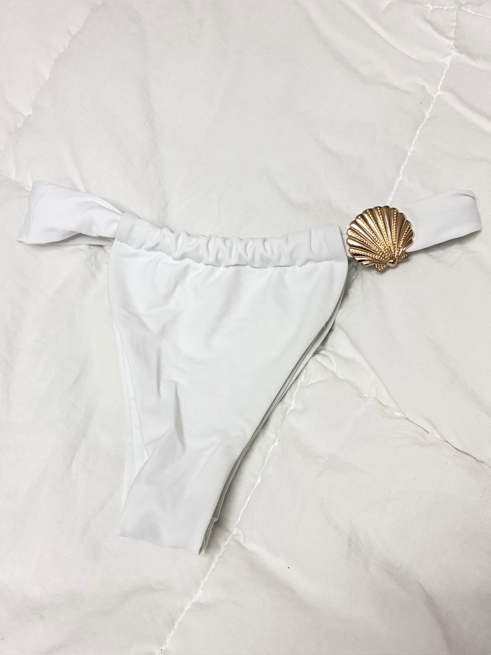 White bikini bottoms with gold shell detail